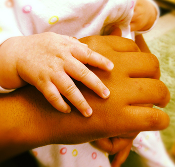 a child's hand on a grown-ups hand